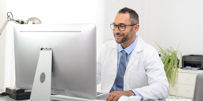 An audiologist at their desk.