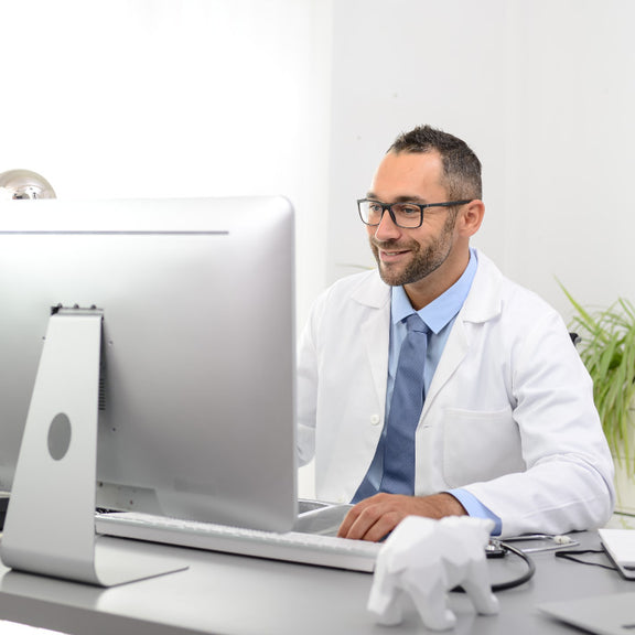 An audiologist at their desk.