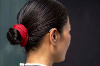 Someone wearing a Signia IX hearing aid on their right ear.