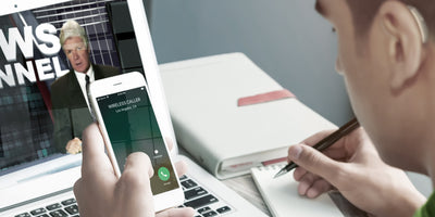 Someone connecting their hearing aid to their iPhone.