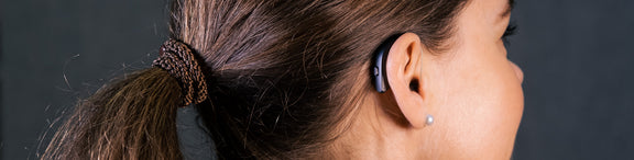 A person wearing a Resound hearing aid.