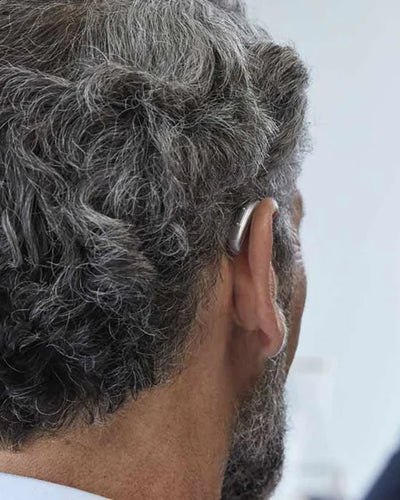 man wearing phonak hearing aid behind ear