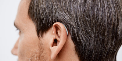 A mean wearing a Signia hearing aid.