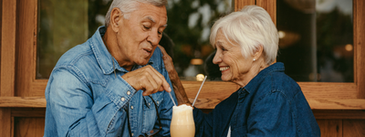 people with hearing aids chatting a table outside