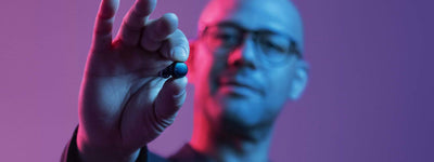 man holding signia active hearing aid in black