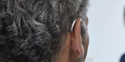 man wearing phonak hearing aid behind ear