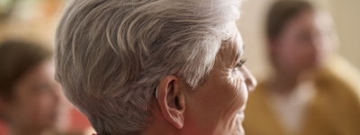 A woman wearing a Resound Nexia hearing aid.