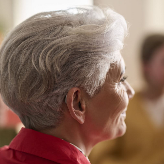 A woman wearing a Resound Nexia hearing aid.