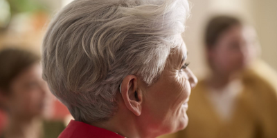 A Resound Nexia hearing aid on someone's ear.