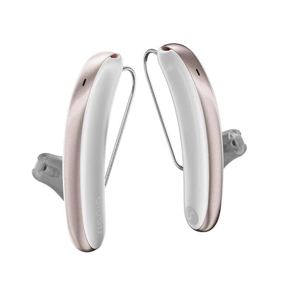 A pair of Signia Styletto IX 7 kit hearing aids in white and rose gold.